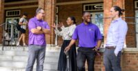 Boyd Scholars Amy Jordan and Breyon Dent (center) talk with lecturers Joe Chappa (left) and Michael Kiernan on the steps of Holtzendorff Hall, the historic YMCA building on campus. (Photo/Clemson University)