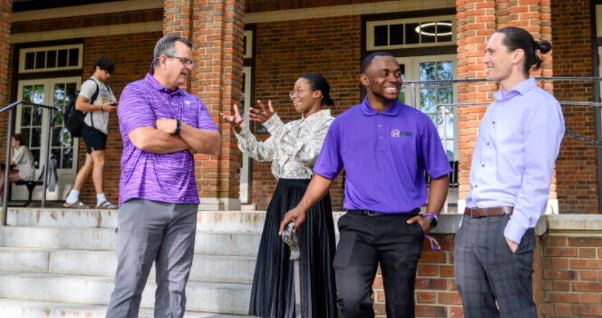 Boyd Scholars Amy Jordan and Breyon Dent (center) talk with lecturers Joe Chappa (left) and Michael Kiernan on the steps of Holtzendorff Hall, the historic YMCA building on campus. (Photo/Clemson University)