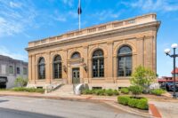 Coldwell Banker Caine recently welcomed more than 80 guests at the grand opening of its Anderson office, located in the restored 1912 U.S. Post Office at 401 N. Main St. (Photo/Coldwell Banker Caine)|Coldwell Banker Caine worked in collaboration with SHLTR Architects and The Boardman Group to preserve key architectural details from the original limestone columns and terrazzo floors to restored walk-in safes and the reinstallation of the buildings rooftop flagpole. (Photo/Coldwell Banker Caine)