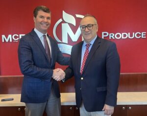 Carter McEntire (left), newly appointed vice president of food service, and John P. Olivo, president, Fresh Express, and shake hands following the successful acquisition of McEntire Produce by Fresh Express. (Photo/Fresh Express)