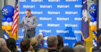 Walmart Distribution General Manager James Bright speaks during dedication ceremonies for the new facility. (Photo/Walmart U.S.)|Walmart associates cut the ribbon to open the new 725,000-square-foot perishable distribution center that will supply 180 stores and create 600 jobs. (Photo/Walmart U.S.)